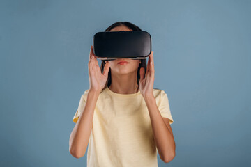 Virtual reality headset. Young girl is against background
