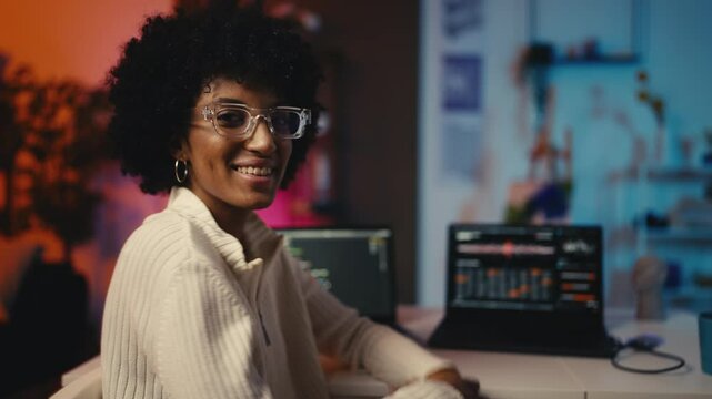 Portrait of female IT specialist working with software on laptop, tech career