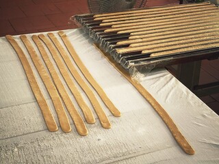 Coconut candy strips in a preform before cutting and packaging. Thoi Son Island coconut candy factory, Vietnam sweets.