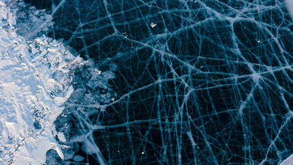 A mesmerizing aerial view of Lake Baikal's icy surface, showcasing intricate patterns and textures of the frozen landscape.