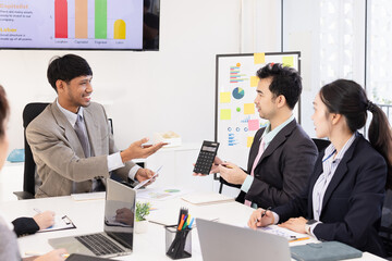 Group of business people working together with dashboard analysis and data management a meeting table in an office.