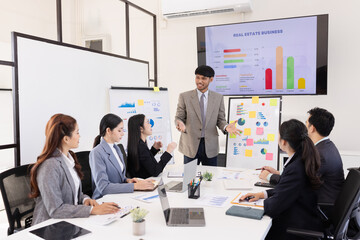 Group of business people working together with dashboard analysis and data management a meeting table in an office.
