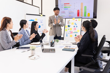 Group of business people working together with dashboard analysis and data management a meeting table in an office.