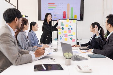 Group of business people working together with dashboard analysis and data management a meeting table in an office.