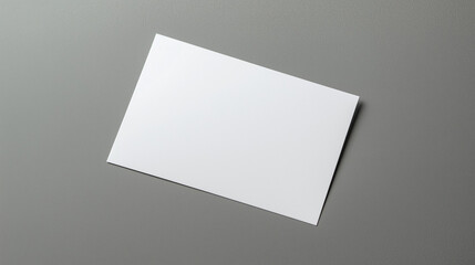 Blank white card on a flat surface, symbolizing simplicity and clarity in design.