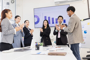 Happy excited asian business people teamwork brainstorm in modern office, successful start and good marketing plan concept.