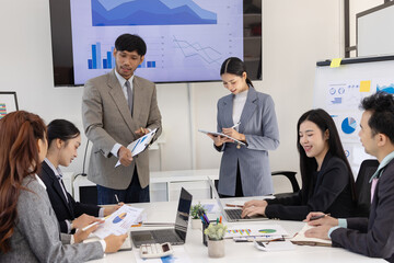 Group of business people working together with dashboard analysis and data management a meeting table in an office.
