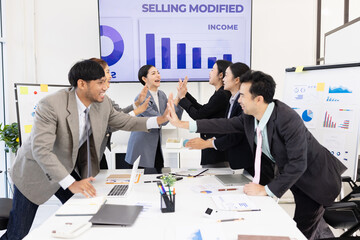 Group of business people working together with dashboard analysis and data management a meeting table in an office.