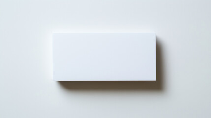 Blank white card on a flat surface, symbolizing simplicity and clarity in design.