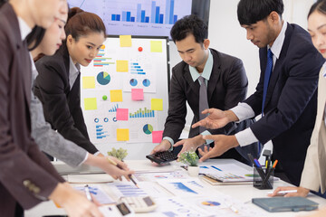 Group of business people working together with dashboard analysis and data management a meeting table in an office.