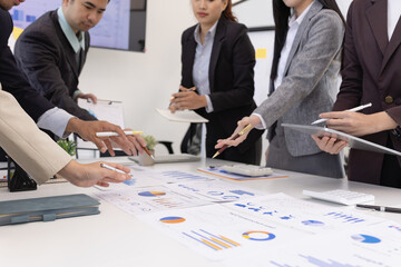Group of business people working together with dashboard analysis and data management a meeting table in an office.