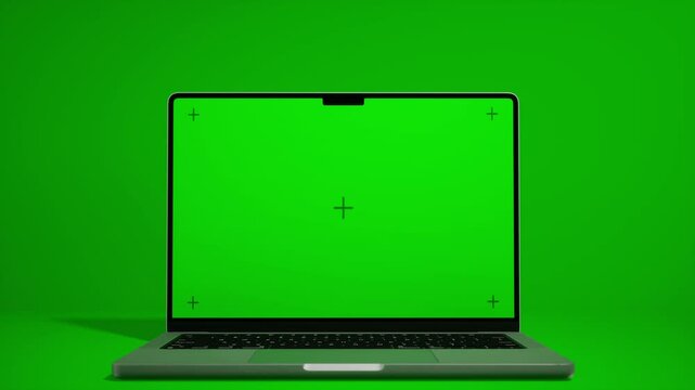 laptop with green screen tracking mark  on green background for chromakey