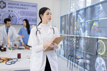 Female doctor with Patient x-ray film interface at room lab in hospital, Doctors looking CitiScan report film, Healthcare and medical concept.