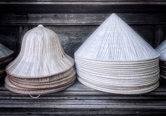 Male and female style of Vietnamese conical straw hat - native name nón lá.