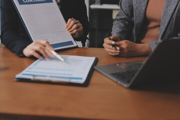 Judge gavel with Justice lawyers having team meeting at law firm background. Concepts of Law and Legal services.