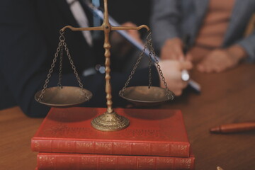 Judge gavel with Justice lawyers having team meeting at law firm background. Concepts of Law and...