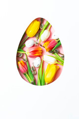 Egg-shaped cutout filled with tulips, willow branches, and Easter eggs. Festive floral arrangement for Easter and spring.