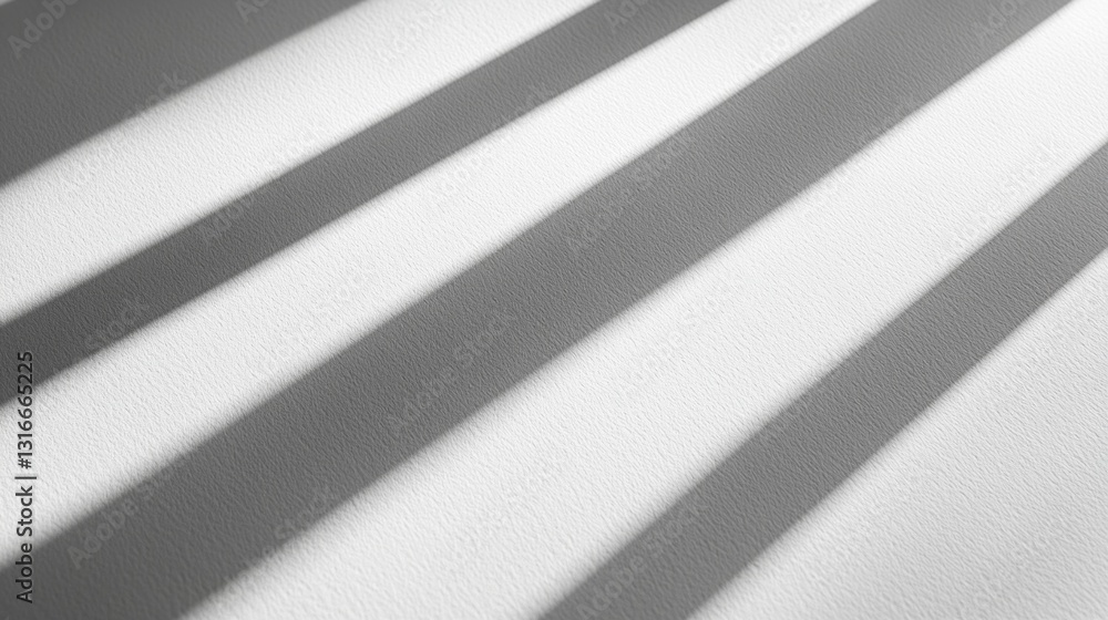 Poster soft, elongated shadows lie gracefully across a smooth, white surface, created by beams of warm afte