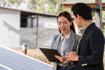 Sustainable business collaboration. Professionals discussing solar energy solutions and strategies outdoors.