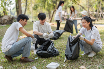 Volunteers participating in a community cleanup event in a park, promoting sustainability and...
