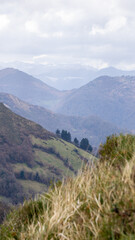 Naklejka premium Mountain landscape on a cloudy day of a deep valley