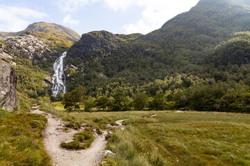Steall Waterfall, a breathtaking natural wonder in the Scottish Highlands, from rugged cliffs into...