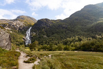 Steall Waterfall, a breathtaking natural wonder in the Scottish Highlands, from rugged cliffs into...