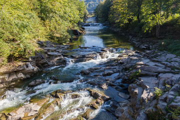 Cascade waterfall on a mountain river in sunny day