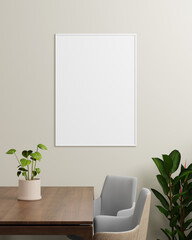 A white photo frame hanging on a beige wall with a table, plant, and chairs, offering a calm, minimalist background for design or photography displays.