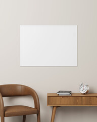 White horizontal photo frame hanging on a soft-colored wall with a modern desk, brown chair, books, and clock.