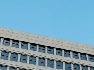 Contemporary architecture with a clean, minimalistic corner and blue sky.