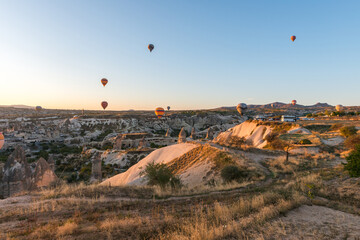 Colorful hot air balloon flying over Cappadocia, Turkey. Hot air balloons flying in sunrise sky.