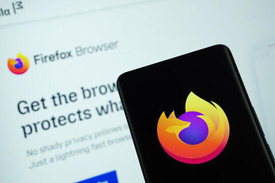Dhaka, Bangladesh- 08 March 2025: mozilla firefox logo is displayed on a smartphone screen, with the mozilla firefox website visible on a computer screen in the background.