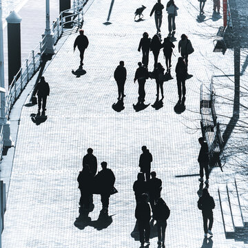silhouettes and shadows of people walking through the streets of Bilbao