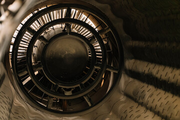 A large, circular object with a black and silver color scheme. The object appears to be a machine or a piece of equipment, possibly a fan or a turbine