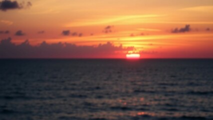 Fototapeta premium Suns descent on sea horizon showcases breathtaking beauty with vibrant colors calm waters and a deep