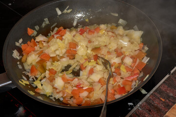 Close-up of fresh vegetables sautéing in a pan for a delicious homemade dish