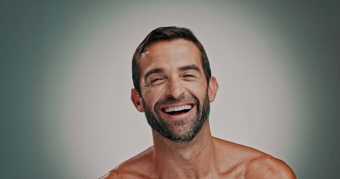 Face, smile and man laugh for skincare with facial glow, natural cosmetics and dermatology results. Portrait, person and funny joke with grooming routine, self care and treatment on studio background