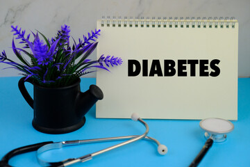 stethoscope and alarm clock with the word Diabetes Type 2. health and disease concept