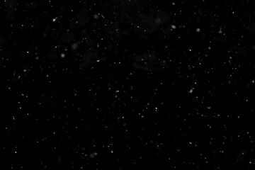 Texture of natural falling snow on black background.