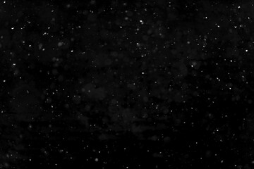 Texture of natural falling snow on black background.