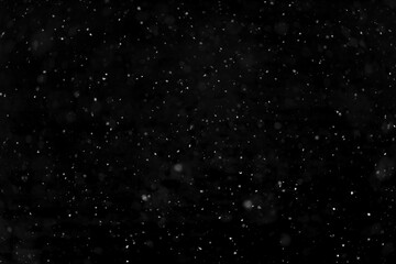 Texture of natural falling snow on black background.