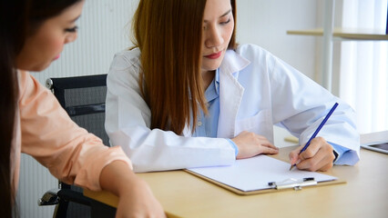 Obraz premium Woman doctor holding hands patient encourage cheer up consultation at hospital medicare treatment clinic. Doctor talking to patient support giving hope listening takecare for mental health therapy