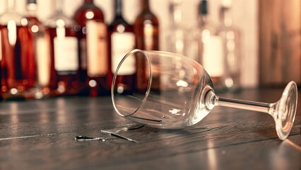 Close-up of a shattered wine glass on a dark wooden table, symbolizing the dangers of excessive drinking and alcohol abuse, with a focus on broken glass and safety concerns.