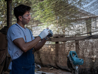Carpenter working on woodworking use cartridge meter measuring in carpentry shop.