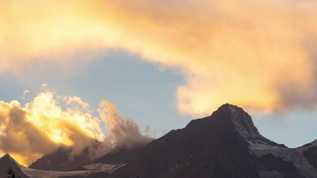 4K Timelapse of Himalayan mountains during sunset in Keylong, Himachal Pradesh, India. Clouds moving over mountains during sunset. Timelapse of clouds and mountains. Indian Himalayas