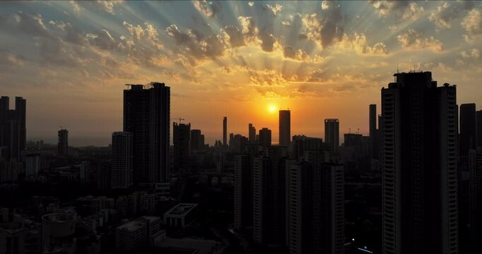 Golden Horizons: Captivating Evening Aerial of Mumbai's Skyline at Sunset, Over Lower Parel, Mahalaxmi, and Currey Road. Silhouette shot of Mumbai's skyline in the evening.