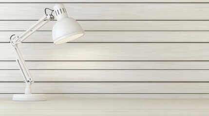 Minimalist white desk lamp with an adjustable arm on a wooden workspace desk