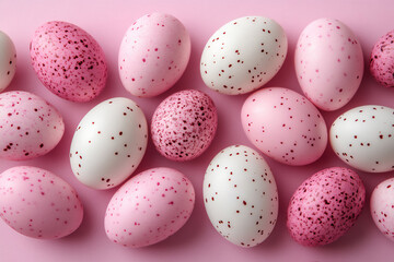 photo of a pattern made from pink and white chocolate eggs on a light past