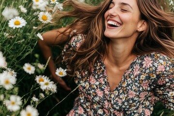 Naklejka premium The beautiful long-haired woman was smiling in nature, wearing a summer dress, with white flowers in the green grass. Sunlight and shade played on her face.